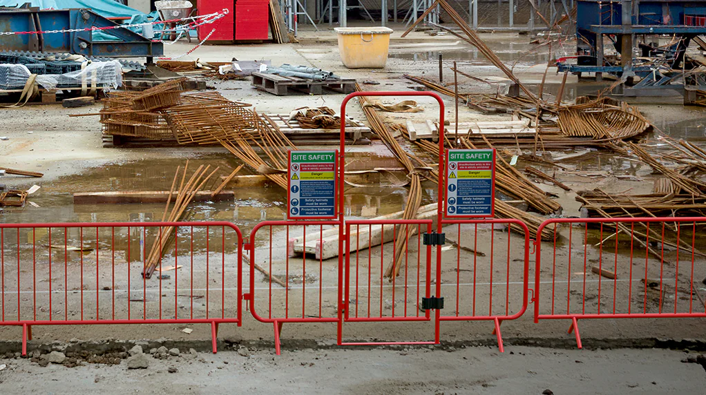 Walkthrough Barrier Sign Holders shown mounted to a walkthrough barrier on a building Site